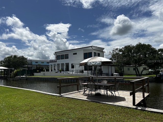 exterior space featuring a water view, a lawn, and a patio