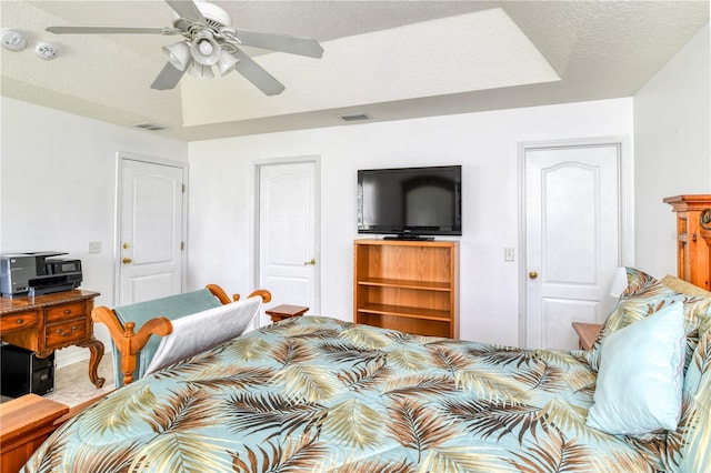 bedroom featuring a textured ceiling and ceiling fan