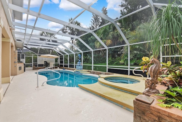 view of swimming pool featuring glass enclosure, a patio area, and a pool with connected hot tub