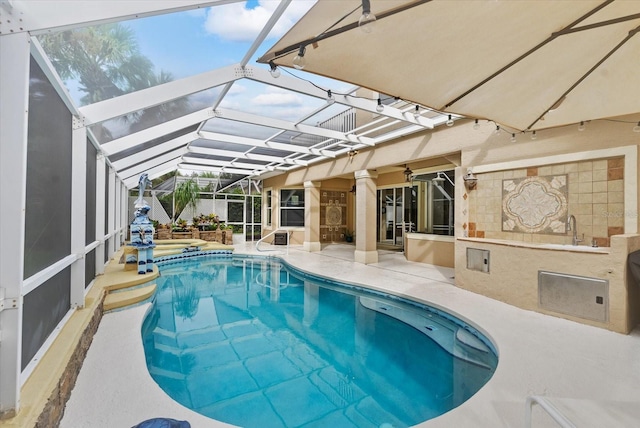 pool with a lanai and a patio area