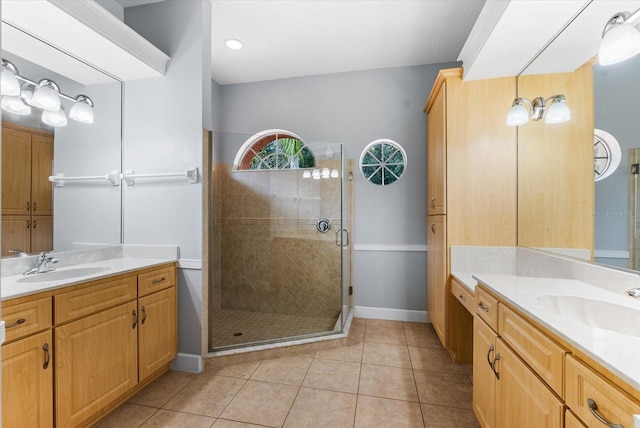 bathroom with a sink, two vanities, a shower stall, and tile patterned floors