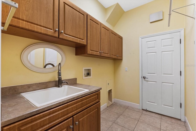 laundry area with washer hookup, a sink, cabinet space, light tile patterned floors, and baseboards