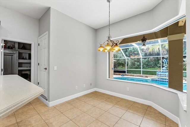 unfurnished dining area featuring light tile patterned floors and baseboards