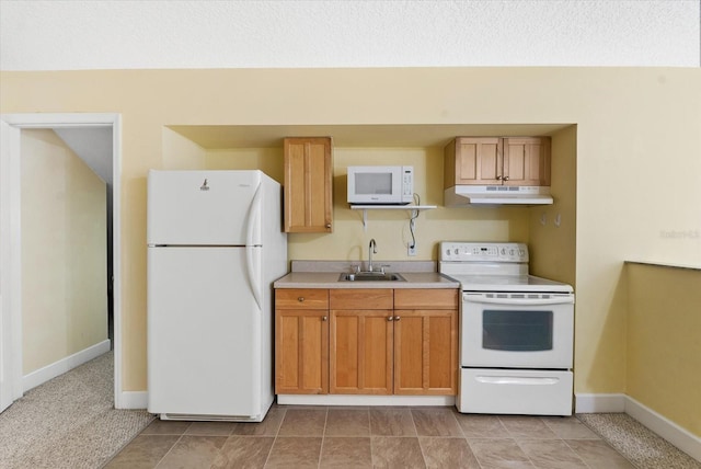 kitchen featuring baseboards, under cabinet range hood, light countertops, white appliances, and a sink