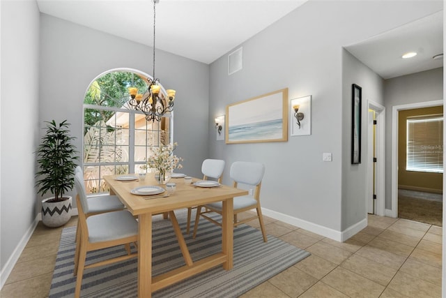 dining area featuring an inviting chandelier, light tile patterned floors, visible vents, and baseboards