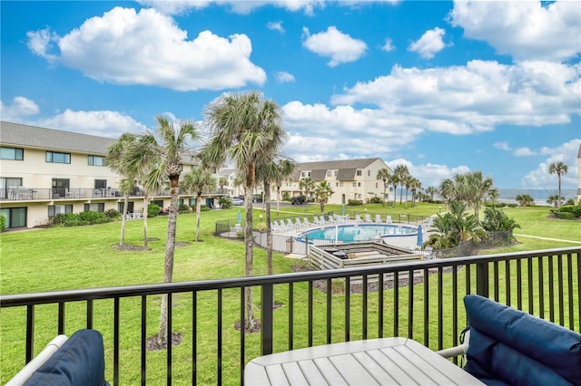 deck with a community pool and a lawn