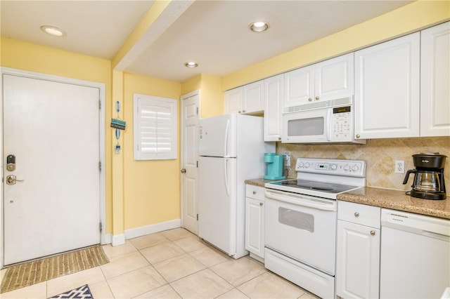 kitchen with light tile patterned floors, white appliances, white cabinetry, and tasteful backsplash