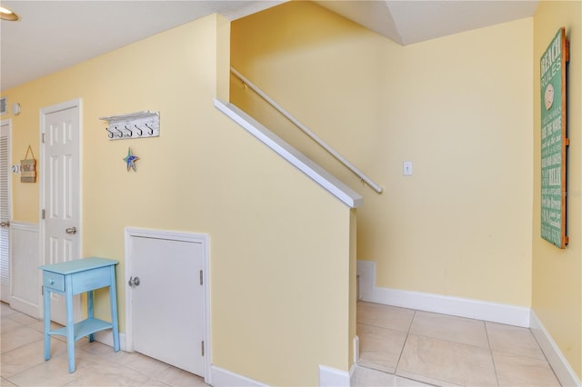 stairway with tile patterned floors