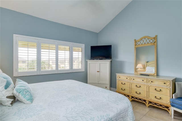 bedroom with vaulted ceiling and light tile patterned floors