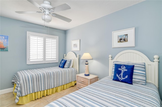 tiled bedroom featuring ceiling fan