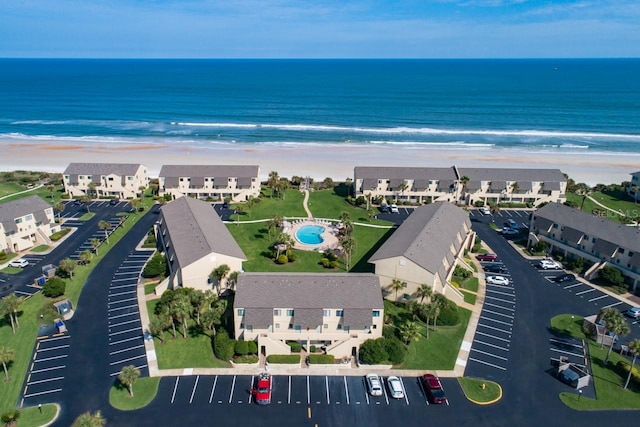 bird's eye view with a water view and a beach view