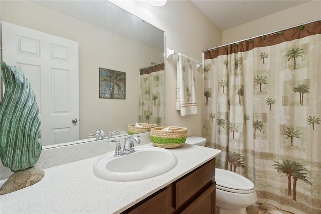 bathroom with vanity, toilet, and curtained shower