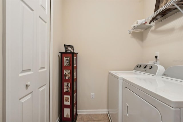 laundry area with light tile patterned floors and washer and clothes dryer