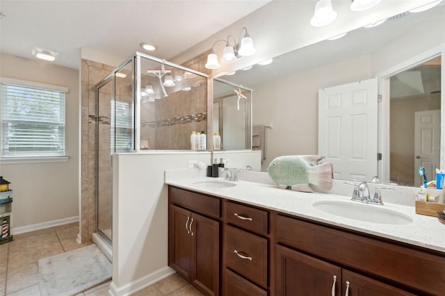 bathroom featuring vanity, a shower with shower door, and tile patterned floors