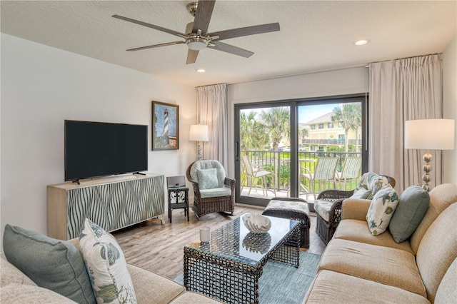 living area featuring a ceiling fan, recessed lighting, a textured ceiling, and wood finished floors