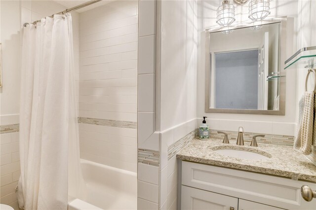 bathroom with shower / bath combo and vanity