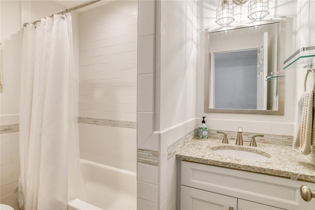 bathroom featuring a notable chandelier, vanity, and shower / tub combo with curtain