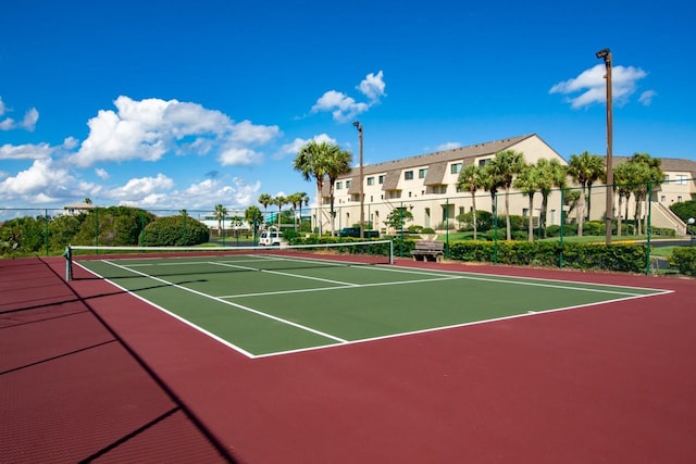 view of tennis court with basketball hoop