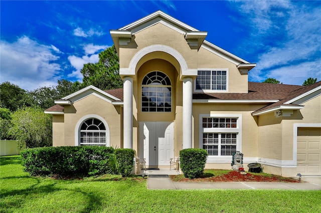 view of front of home featuring a front yard and a garage