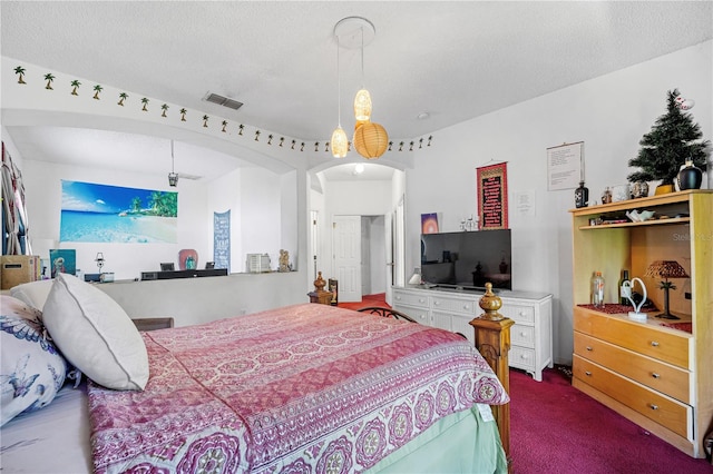 bedroom with carpet floors and a textured ceiling