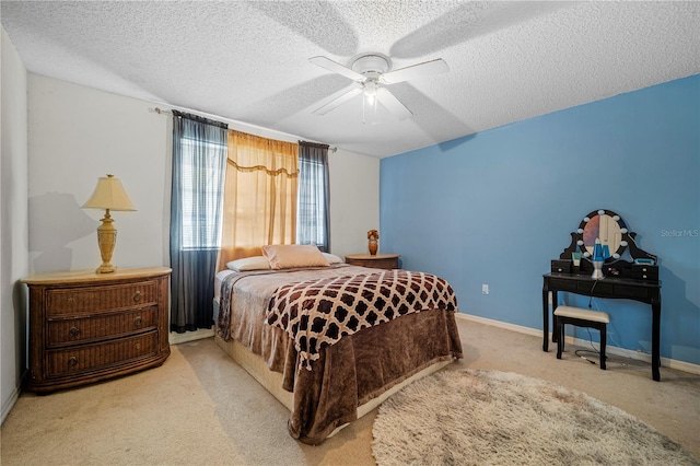 carpeted bedroom featuring a textured ceiling and ceiling fan