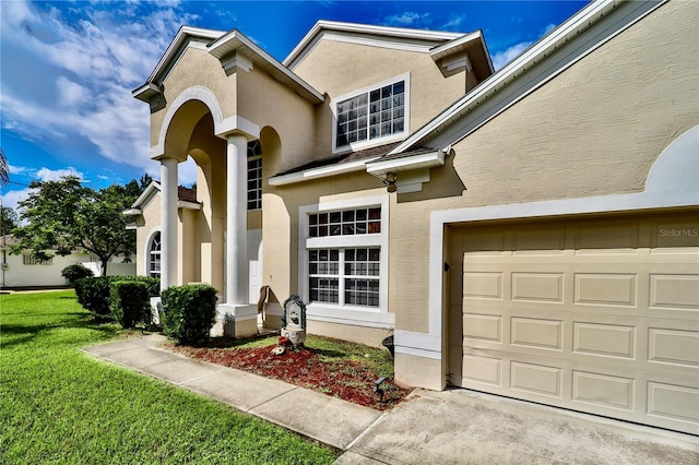 view of front of house with a garage and a front lawn