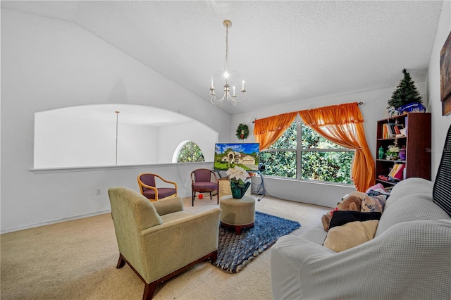 living room featuring an inviting chandelier, lofted ceiling, carpet flooring, and a textured ceiling