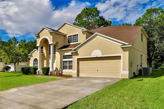 view of front facade featuring a front yard, cooling unit, and a garage