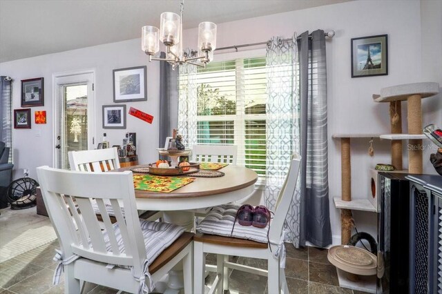 dining room featuring a healthy amount of sunlight and a notable chandelier