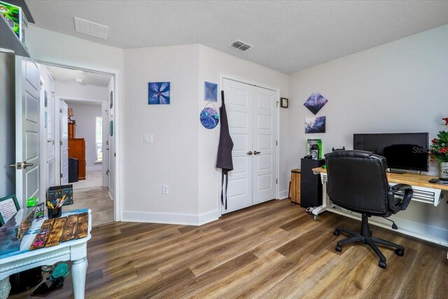 office space with a textured ceiling and hardwood / wood-style floors