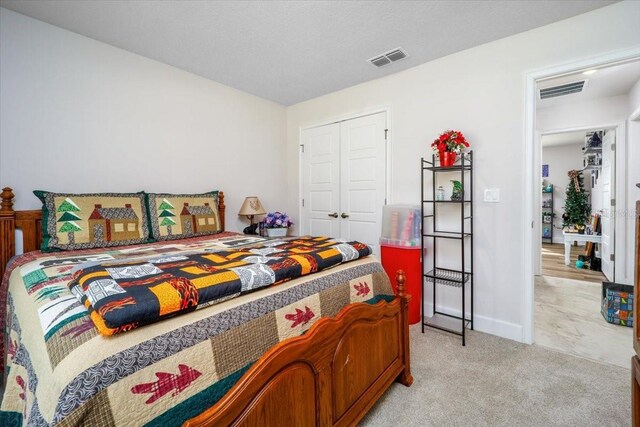 carpeted bedroom with a closet