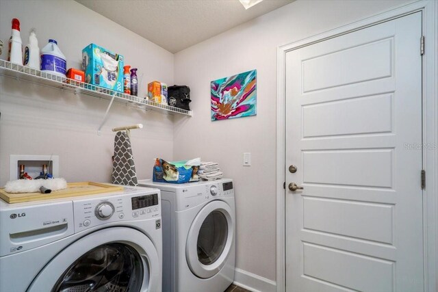 washroom with washing machine and dryer