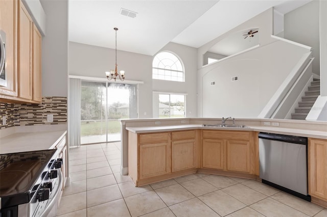 kitchen with decorative light fixtures, white electric stove, sink, stainless steel dishwasher, and light tile patterned flooring