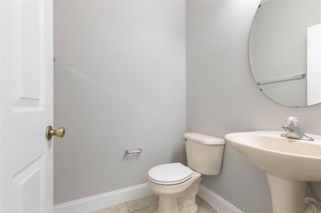 bathroom featuring toilet, sink, and tile patterned floors