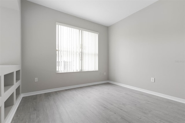 spare room with wood-type flooring