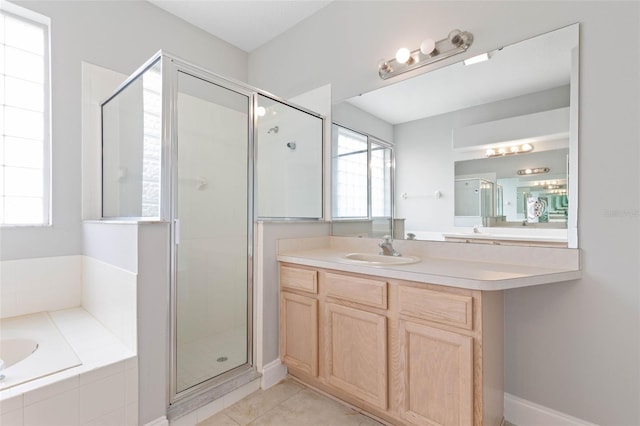 bathroom featuring plus walk in shower, tile patterned flooring, and vanity