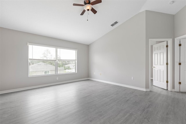 unfurnished room featuring vaulted ceiling, wood-type flooring, and ceiling fan