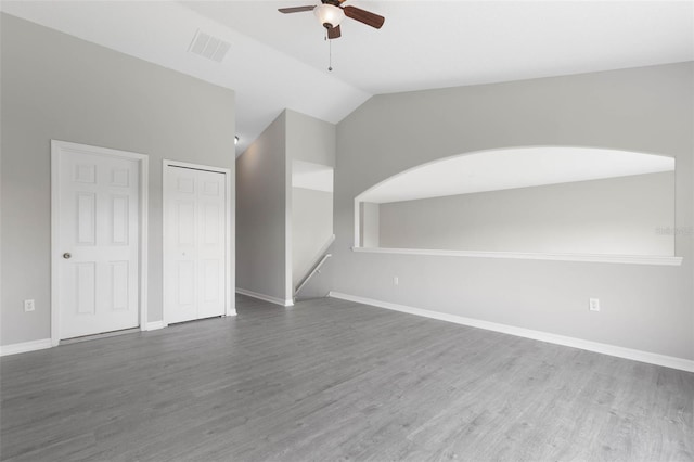 spare room with dark wood-type flooring, ceiling fan, and lofted ceiling