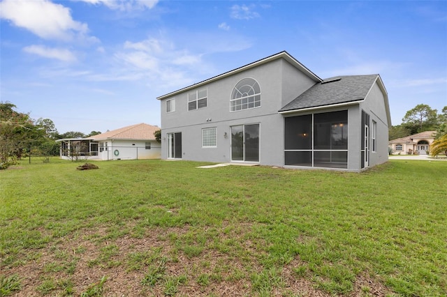 back of house featuring a sunroom and a yard