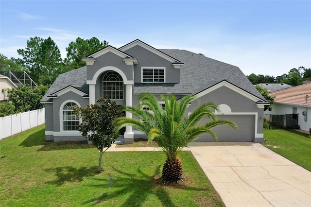 view of front of property featuring a garage and a front yard