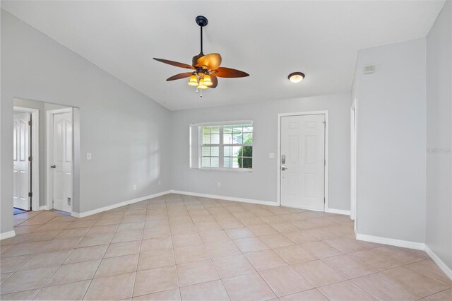 unfurnished room featuring lofted ceiling, ceiling fan, and light tile patterned flooring