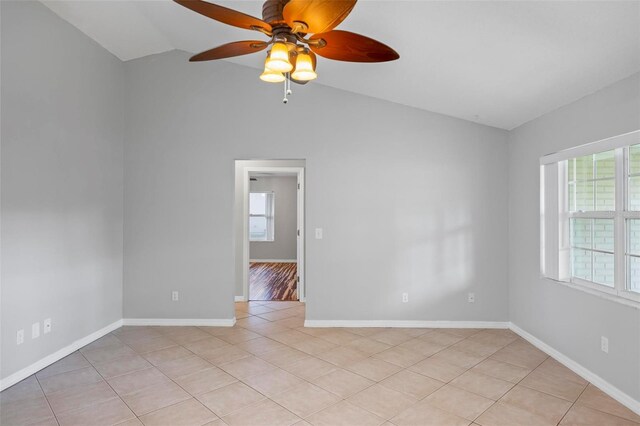 tiled spare room featuring ceiling fan and vaulted ceiling