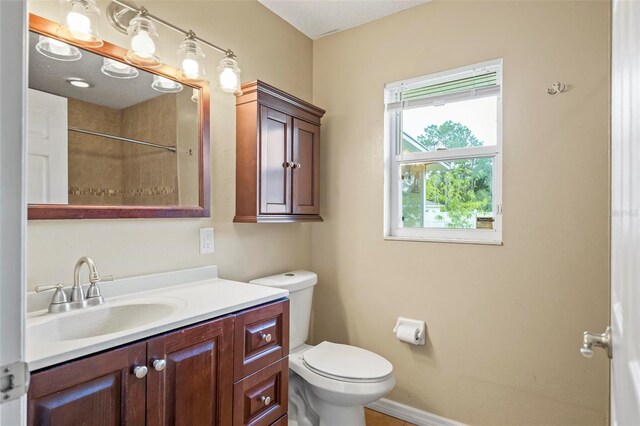 bathroom with vanity, toilet, and walk in shower