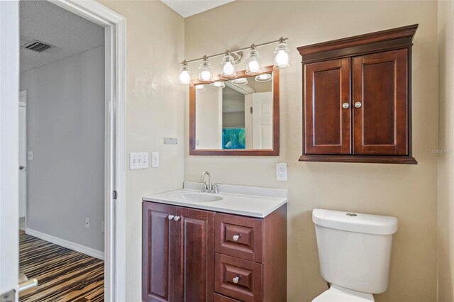 bathroom with toilet and vanity