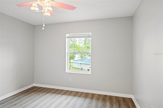 unfurnished room with ceiling fan, light hardwood / wood-style floors, and a textured ceiling