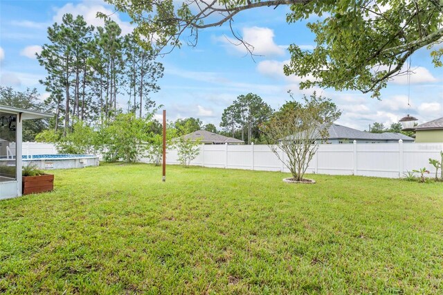 view of yard with a fenced in pool