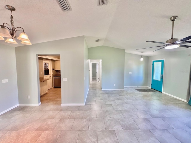 empty room with ceiling fan with notable chandelier, light tile patterned flooring, and vaulted ceiling