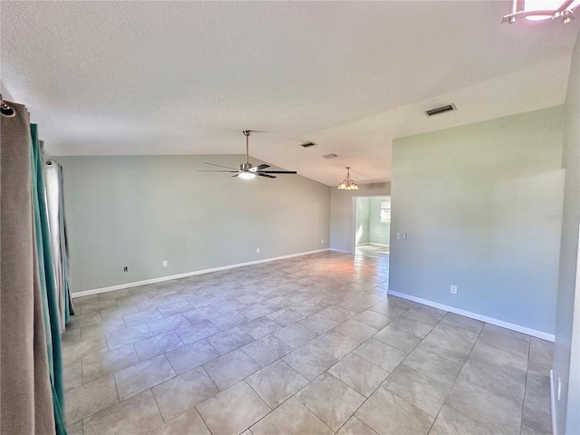 empty room featuring ceiling fan with notable chandelier and lofted ceiling