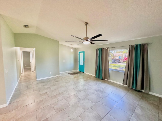 tiled empty room with ceiling fan, a textured ceiling, and lofted ceiling