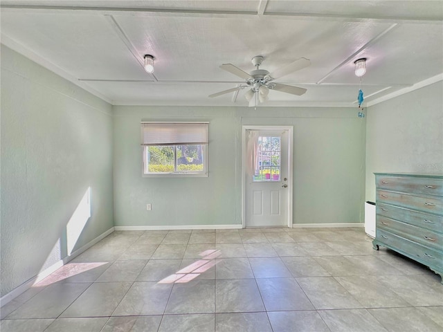 spare room with ceiling fan and light tile patterned floors